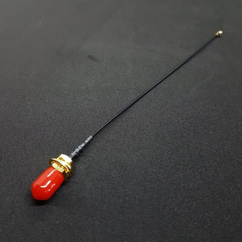 SMA to u.FL adapter cable with the red protective cap fitted on the SMA connector