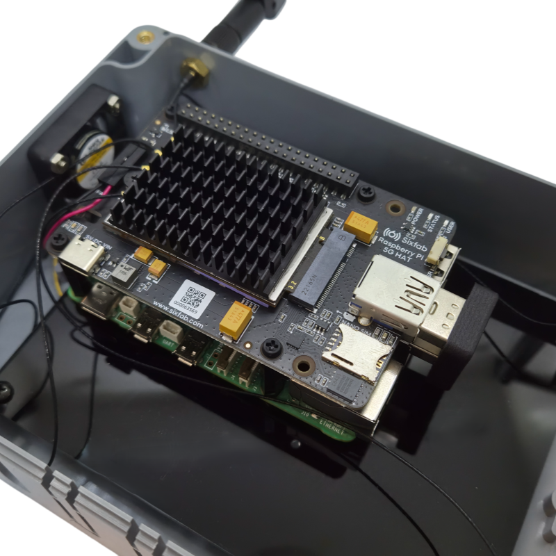 Close-up of the Sixfab 5G HAT v2 inside the enclosure showing the heatsink, Nano SIM area and USB 3.0 bridge