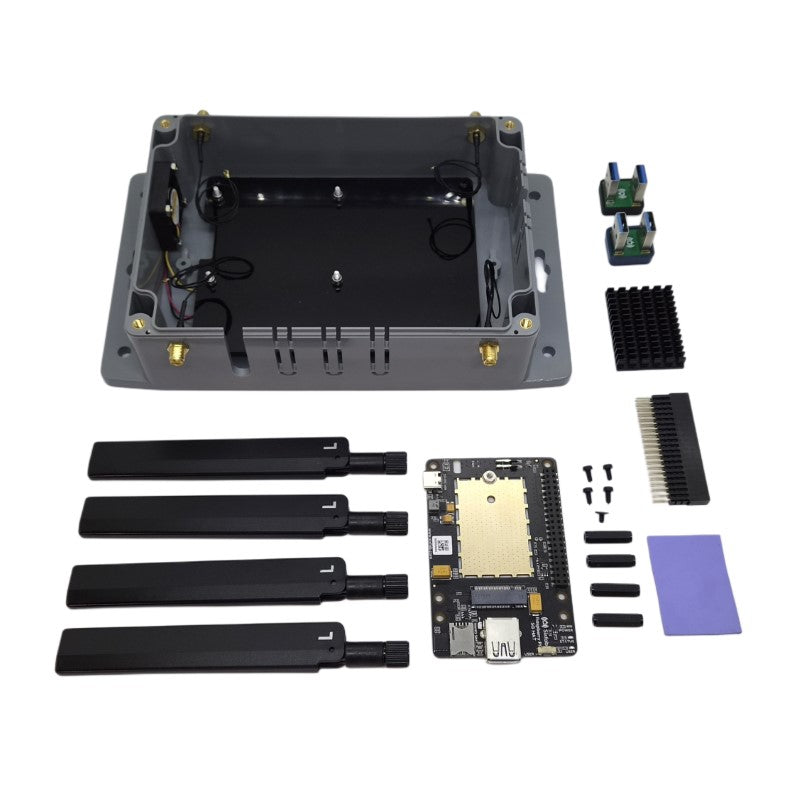 Kit contents laid out: enclosure base with fan, four antennas, 5G HAT v2, two USB 3.0 bridge connectors, heatsink, thermal pad, GPIO header, screws and standoffs